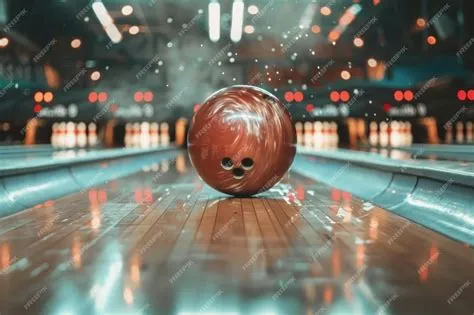 Closeup of a bowling ball hitting pins scoring a strike bottom view and ...