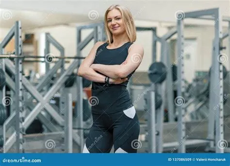 Portrait of Adult Blonde Fitness Woman Personal Trainer with Folded ...