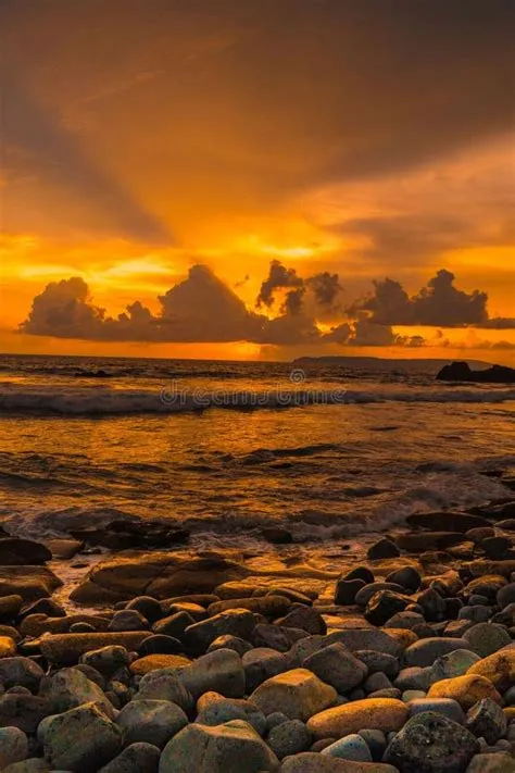 Sunset at the Rocky Beach in Papuma, Jember, East Java, Indonesia Stock ...