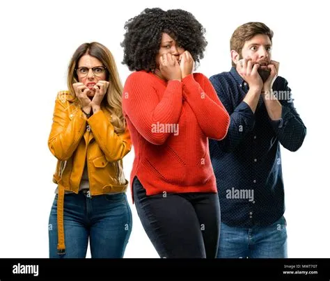 Group of three young men and women terrified and nervous expressing ...