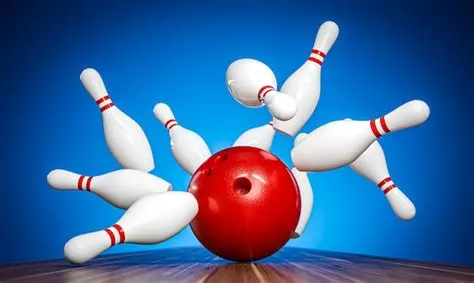 Premium Photo | Bowling ball hitting pins on alley