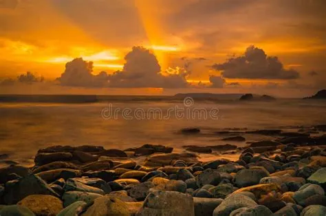 Sunset at the Rocky Beach in Papuma, Jember, East Java, Indonesia Stock ...