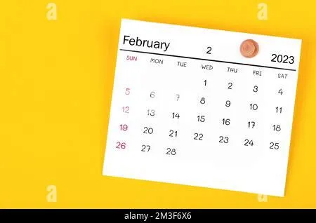 February 2023 and wooden push pin on blue background Stock Photo - Alamy