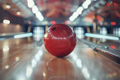 Closeup of a bowling ball hitting pins scoring a strike bottom view and ...