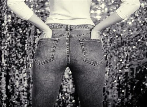 Buttocks. Ass in jeans. Fashion for girls. The young woman put her ...