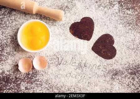 Hearts of flour and rolling pin on light background Stock Photo - Alamy