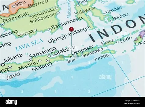 Close up to a Denpasar city with a red pin needle into Indonesia ...