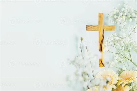 Wooden cross with spring flowers on blue background with copy space ...