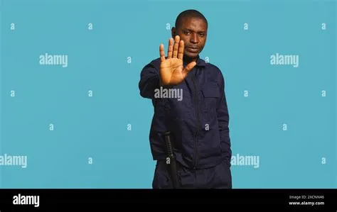 Security guard doing stop sign gesturing, being tasked with preventing ...