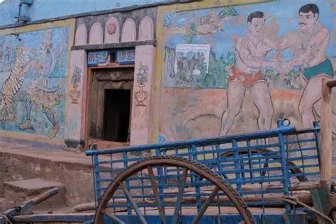 Exterior view of a local rural gymnasium in northern Karnataka. Murals ...