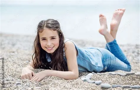 Little Girl Lying On The Beach at Nettie Cox blog