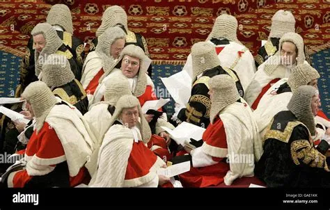 Law Lords sit on the cross benches as they wait in the House of Lords ...