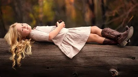 Smiley White Hair Cute Little Girl Is Lying Down On Tree Trunk In Blur ...