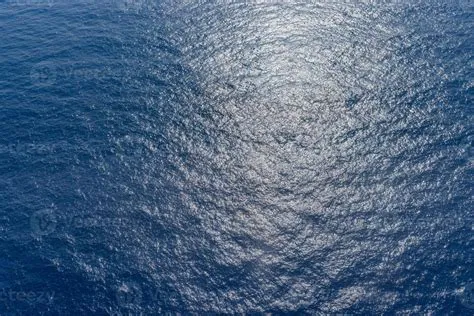 Sea surface aerial view, sunny deep blue ocean background. Ripples ...