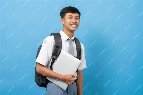 Premium Photo | Indonesian senior high school student holding and using ...