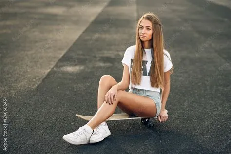 Beautiful young and sexy girl with long hair in a white T-shirt, short ...