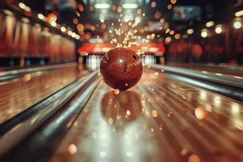 Closeup of a bowling ball hitting pins scoring a strike bottom view and ...