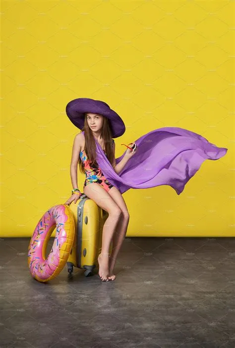 Stunning girl model in a colorful bikini hat pareo with a suitcase ...